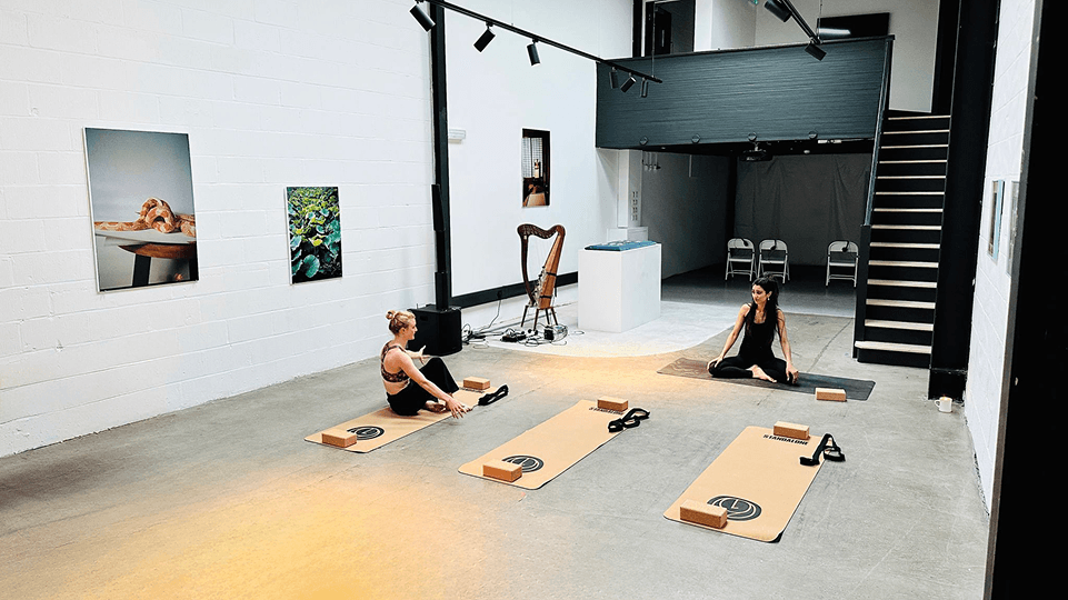 Standalone gallery interior with seated visitors during a workshop.